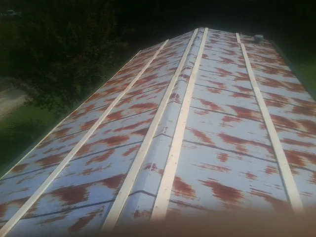 Rusted metal roof panels with new wood purlins before replacement — Storm Damage Roof Repair in Wapanucka by Roofing Brothers